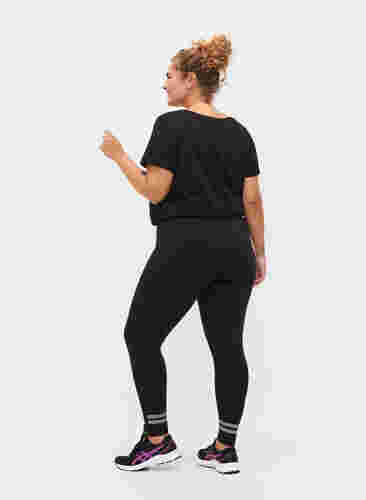 Sportlegging met reflex en fleece aan de binnenkant, Black, Model image number 1