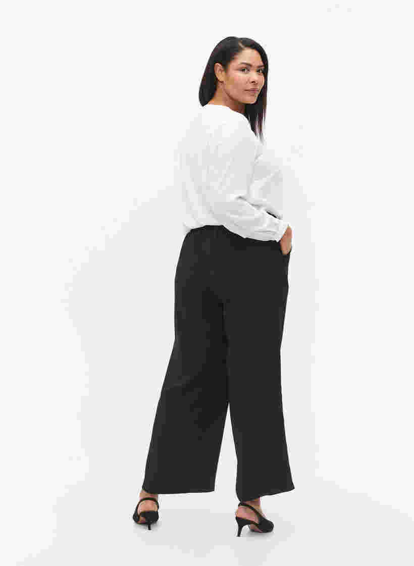 Uitlopende broek met zakken, Black, Model image number 1