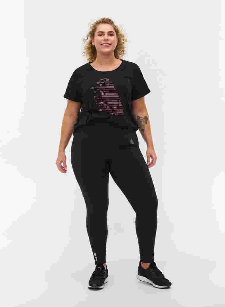 Cropped sportlegging met zakje en reflecterend, Black, Model image number 0
